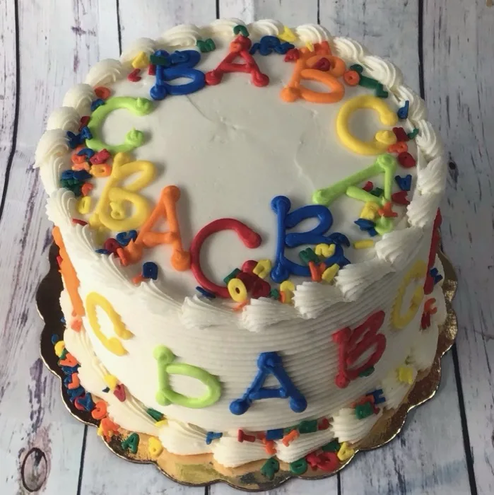 Round cake decorated with colorful fondant alphabet letters