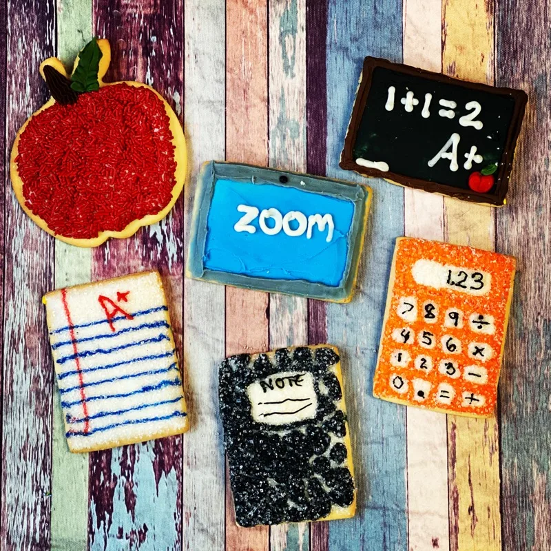Back-to-school decorated sugar cookies including a chalkboard, calculator and Zoom screen design