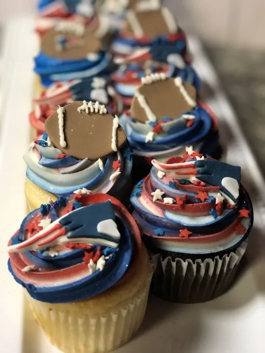 Patriots-themed birthday cupcakes with football fondant toppers