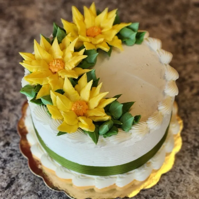 Two-tier cake decorated with buttercream sunflowers