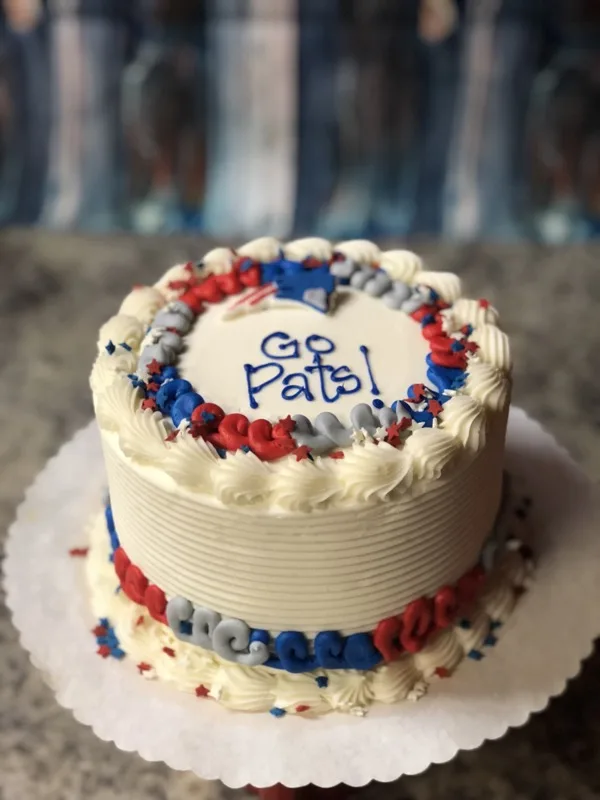 Patriots-themed birthday cupcakes with football and helmet fondant toppers