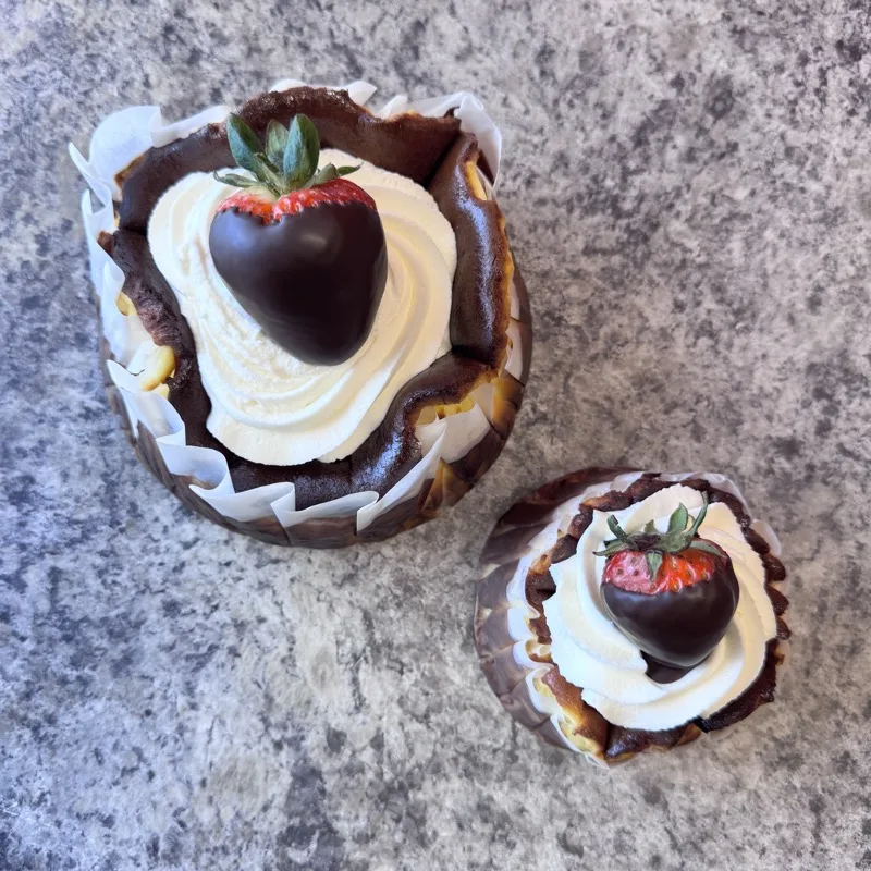 Mini strawberry cheesecakes topped with chocolate-dipped strawberries at Veronica's Sweetcakes